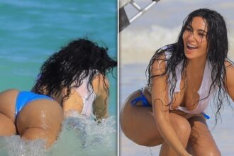Kim Kardashian si tuffa nell'oceano in minuscolo top bianco, i pantaloni bikini