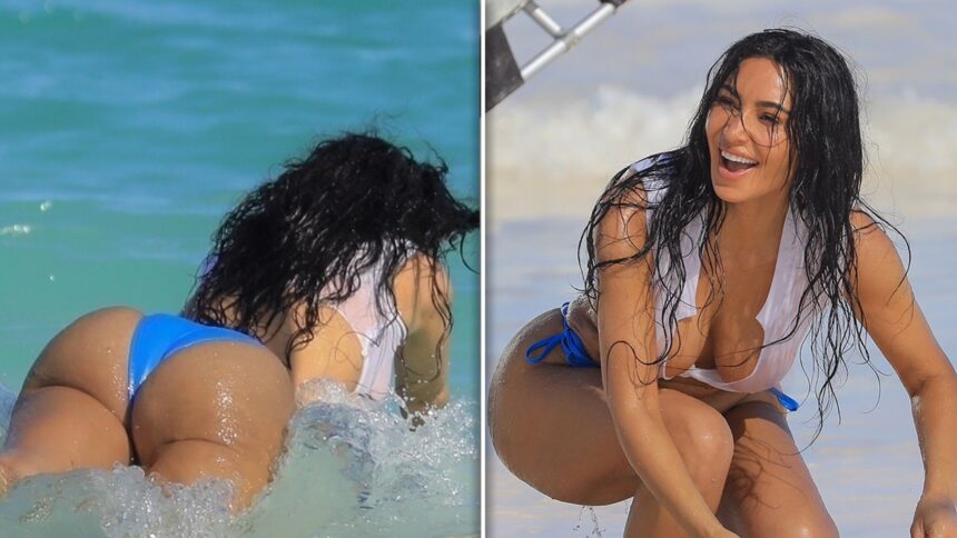 Kim Kardashian si tuffa nell'oceano in minuscolo top bianco, i pantaloni bikini
