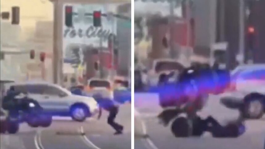 Il conducente ATV sconvolto fa scendere l'ufficiale in Kansas City Street, in video