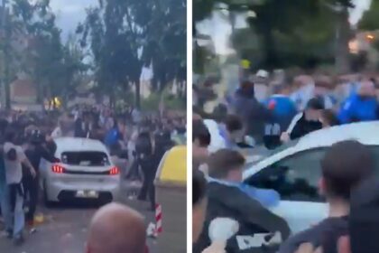 L'auto rampia nella folla di fan fuori dalla partita di calcio, catturato in video