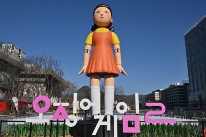 An inflatable Young-hee doll is displayed to promote Netflix's South Korean series "Squid Game Season 2" at Gwanghwamun Square in Seoul on December 26, 2026. (Photo by Jung Yeon-je / AFP) (Photo by JUNG YEON-JE/AFP via Getty Images)